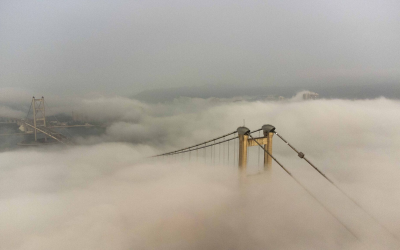 Hong Kong’s Tsing Ma Bridge emerges from the fog this morning